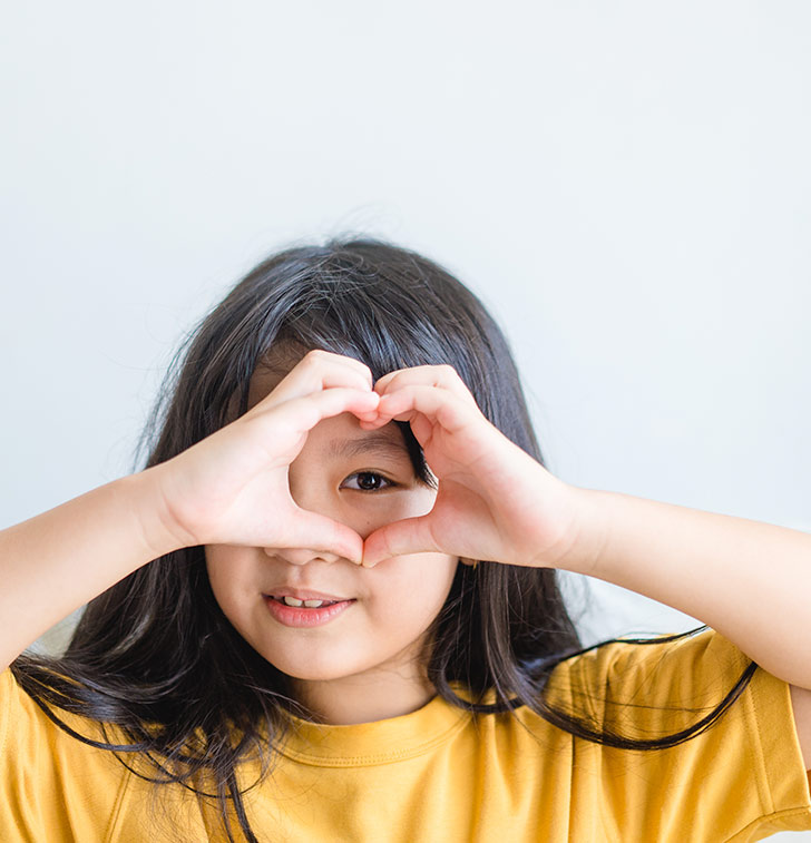 child-heart-hands-love-gesture-yellow-shirt