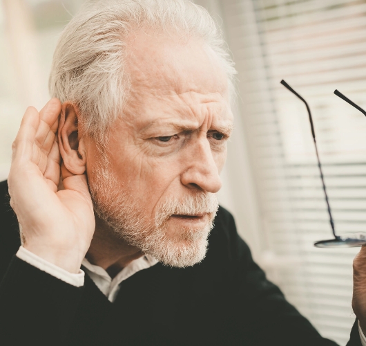 elderly-man-cupping-ear-hearing-difficulty