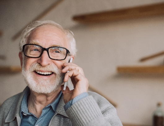 happy-senior-man-on-phone-wearing-glasses