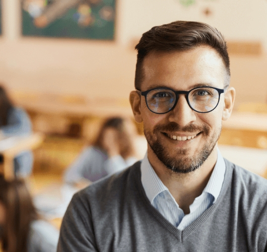 smiling-man-wearing-eyeglasses-in-classroom