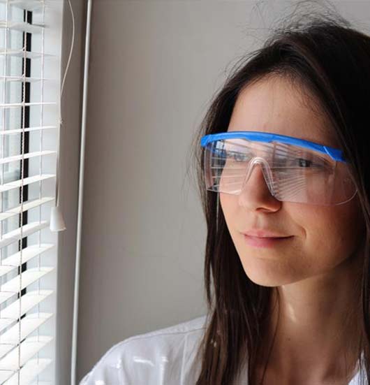 woman-wearing-saftey-eyewear-at-window